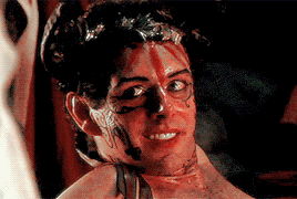 a man with blood on his face is smiling and looking at the camera