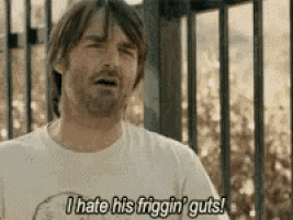 a man is standing in front of a fence and saying `` i hate his friggin ' guts ''