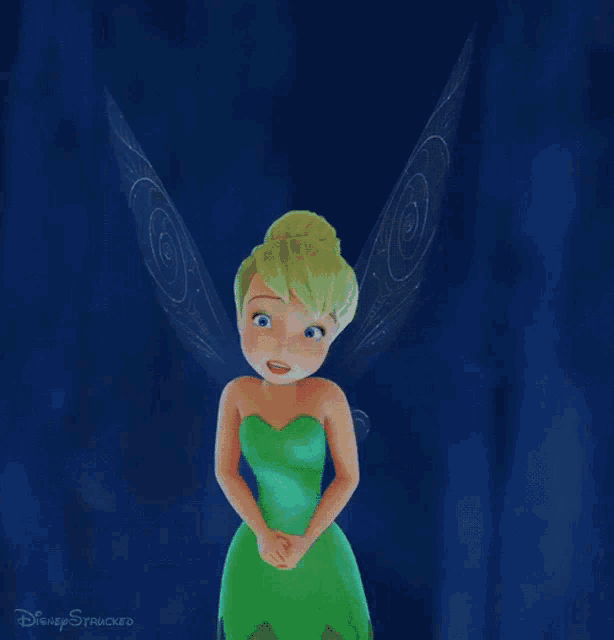 tinkerbell from disney 's tinkerbell is smiling with her hands on her hips