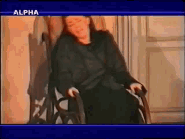 a woman is sitting in a chair with the word alpha on the bottom
