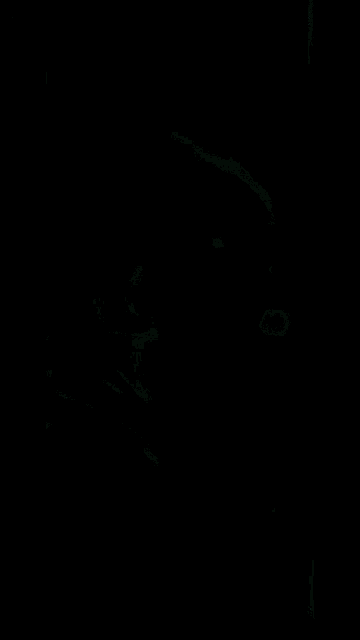 a close up of a person 's face in a dark room with movieclips.com written on the bottom of the screen