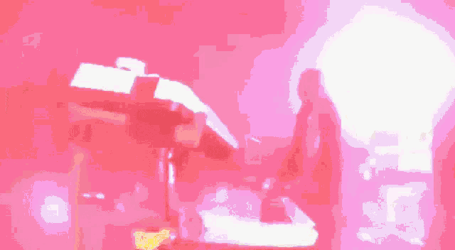 a red background with a white object in the middle of it