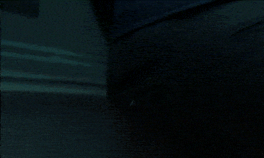 a person 's feet are shown in a dark room with a blue light shining on them