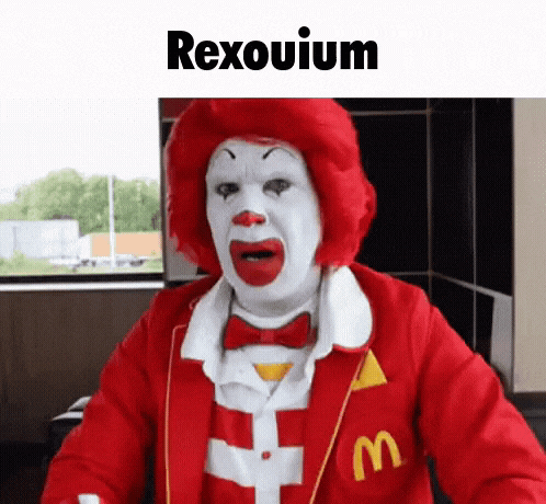 a mcdonald 's clown with a red wig and white face is wearing a red jacket with the letter m on it