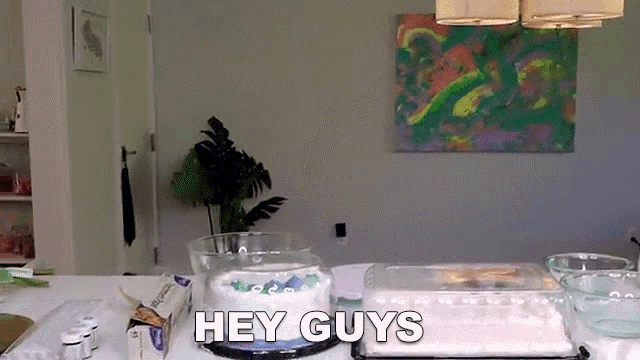 a cake sitting on a table with the words hey guys below it