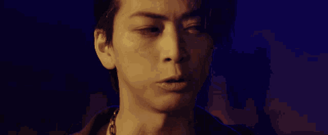 a close up of a man 's face with a serious expression