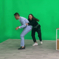 a man and a woman are dancing on a green screen