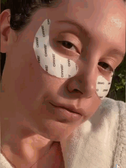 a close up of a woman 's face with patches on her eye