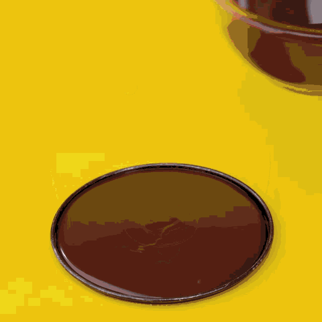 a yellow background with a black circle in the middle of it