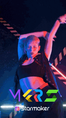 a woman is dancing in front of a sign that says " starmaker "