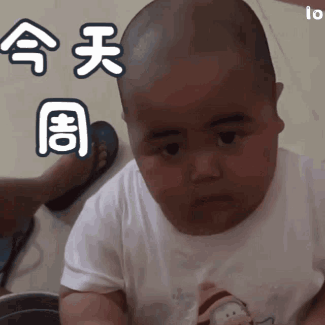 a baby with chinese writing on it 's head