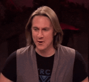 a man with long hair says holy shit on his face