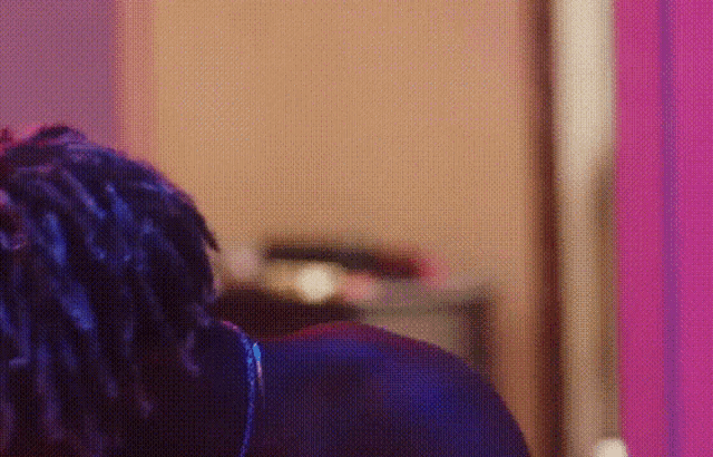 a close up of a person 's back with blue hair