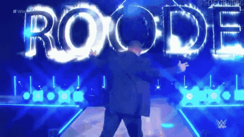 a man in a suit is dancing in front of the word roode .