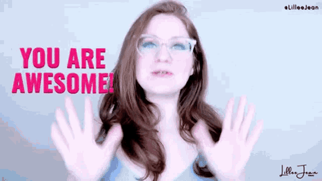 a woman wearing glasses says you are awesome with her hands in the air