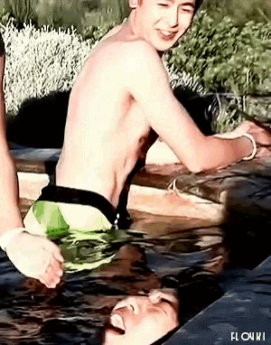 a shirtless man is sitting in a pool of water with the word flow on it