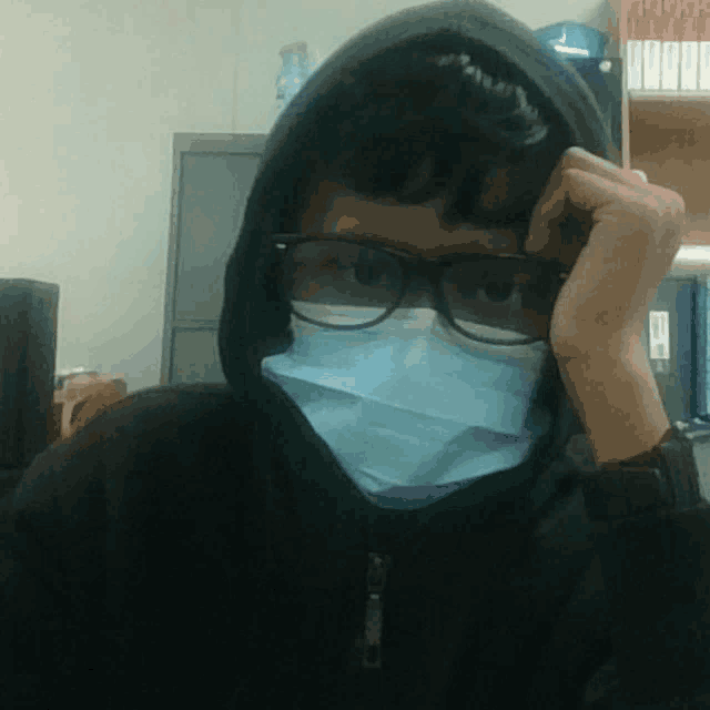a person wearing glasses and a mask with a hood on their head