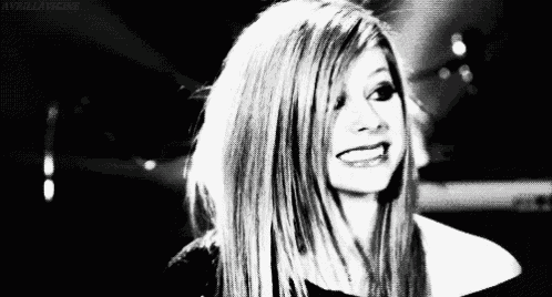 a black and white photo of avril lavigne smiling