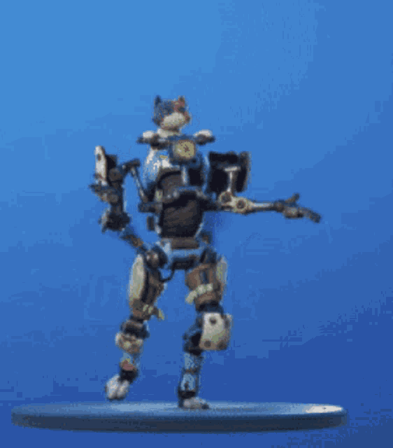 a toy robot is dancing on a blue background