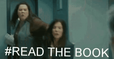two women are standing next to each other in a hallway with the words `` read the book '' written above them .