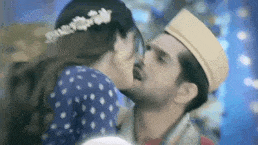 a man and a woman are kissing each other .