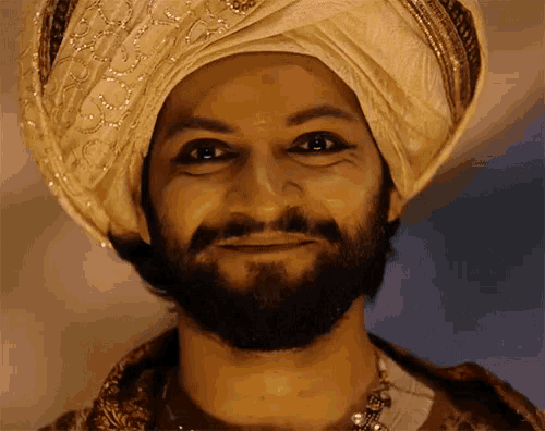 a man with a beard is wearing a turban