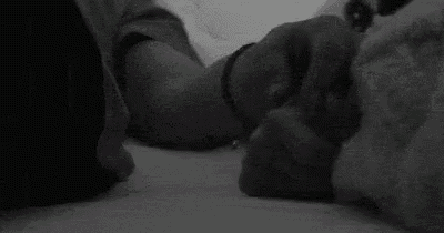 a close up of a person holding another person 's hand in a black and white photo .