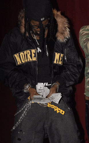 a man wearing a black jacket with the word noire on the front