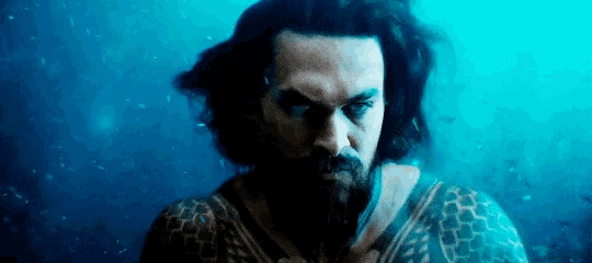a man with a beard is swimming in the water