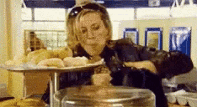 a woman is sitting at a table with a tray of food on it .