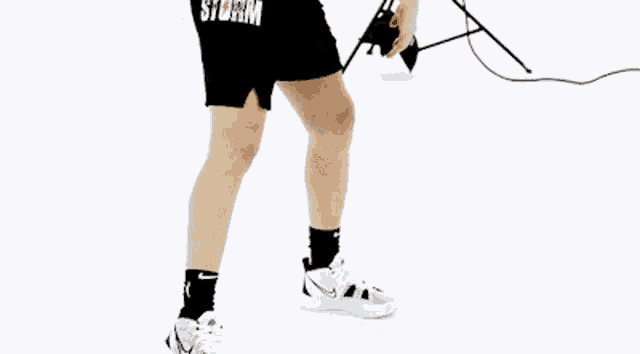 a woman holding a basketball with the number 10 on it