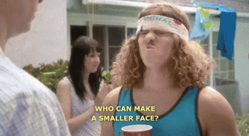 a man with curly hair wearing a headband is holding a cup and making a face .
