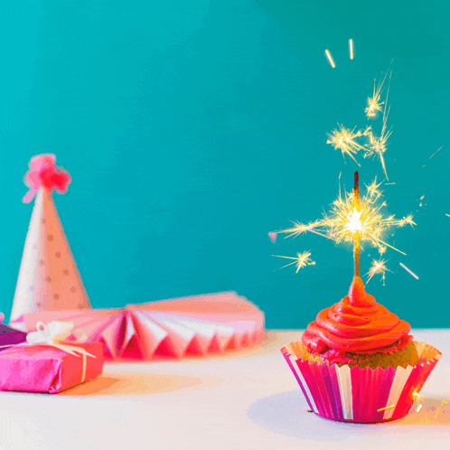a birthday cupcake with a sparkler in it