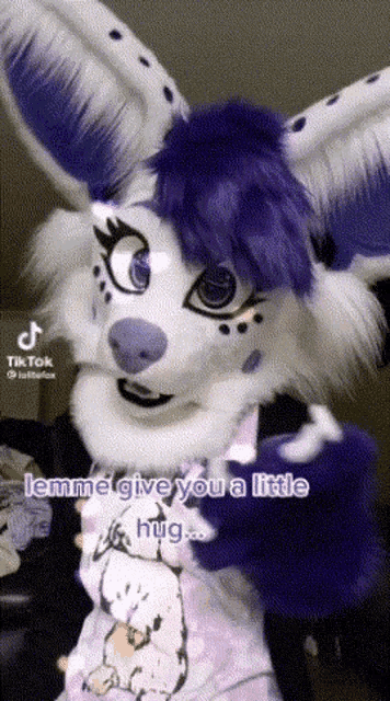 a purple and white furry animal with a tiktok sticker