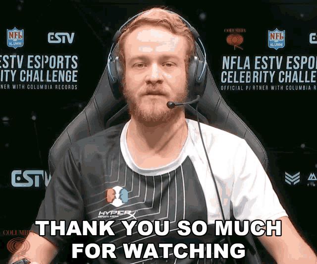 a man wearing headphones and a shirt that says hyperx on it