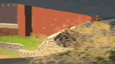 a close up of a painting of a building and a rocky hill