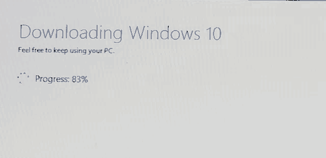 a screen that says downloading windows 10 feel free to keep using your pc progress : 83%