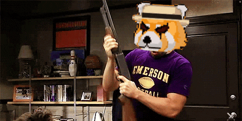 a man wearing a purple shirt that says emerson holds a shotgun