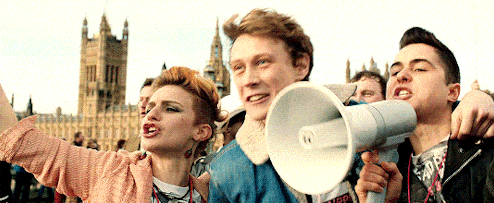 a group of people holding a megaphone with one wearing a shirt that says " save "