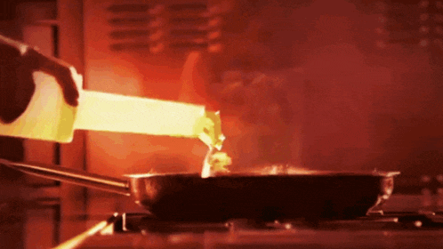 a person is pouring liquid into a frying pan