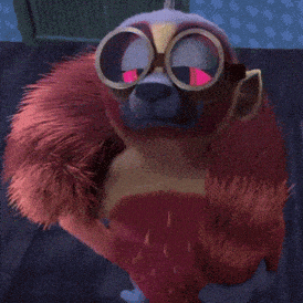 a stuffed animal wearing goggles and a red furry coat