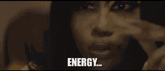 a close up of a woman 's face with the words energy written on it