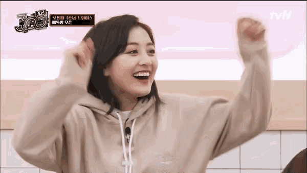 a woman wearing a tan hoodie with the number 360 on the bottom