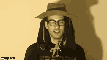 a man wearing a hat and a hoodie that says ' freddy ' on it