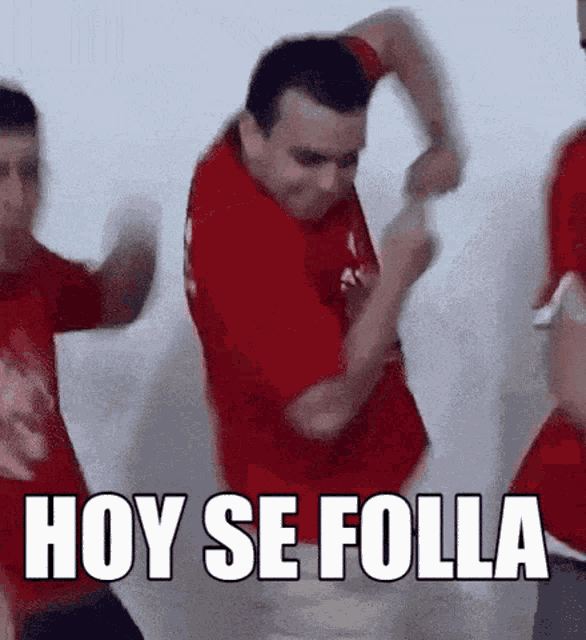 a man in a red shirt is dancing with the words hoy se folla written above him