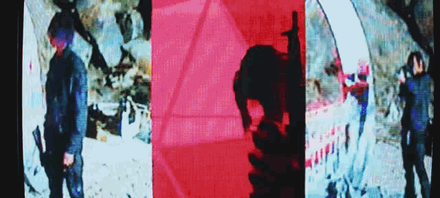 a man with a gun is standing in front of a red and blue background