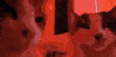 a close up of a person 's face with a red light behind them .