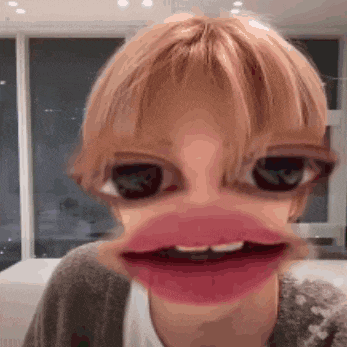 a close up of a person making a funny face with their mouth open .