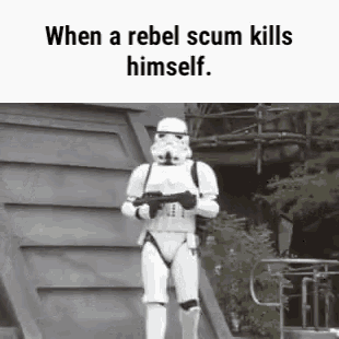 a storm trooper is walking down stairs holding a gun .