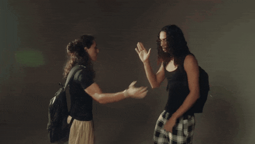 a man with long hair is covering his face with his hands